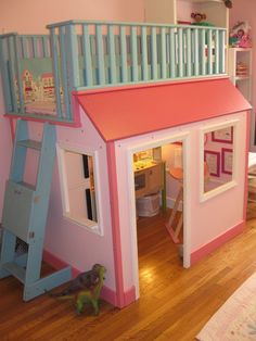 a child's bedroom with a pink and blue loft bed next to a play house