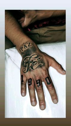 a hand with the words pay here tattooed on it