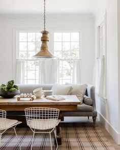 a living room filled with furniture and a wooden table