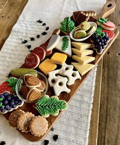 a wooden tray filled with lots of different types of food on top of a table