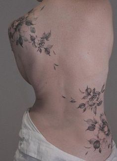 a woman's back with flowers on it