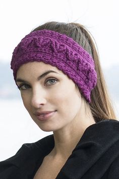 a woman wearing a purple headband and looking off to the side with her hand on her hip