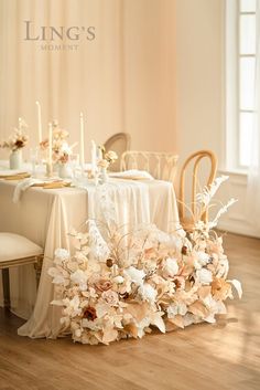 the table is set with flowers and candles