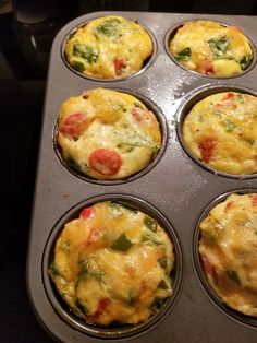 a muffin tin filled with lots of different types of breakfast food in it's pan