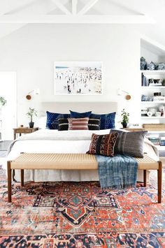 an image of a bed with pillows on top of it and the caption reads, antique serapi rugs were made by small workshop