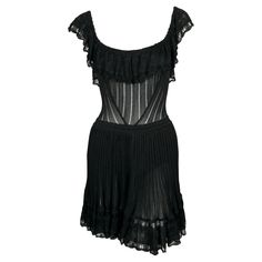 Very rare, jet-black semi-sheer dress with flounced pointelle trim and bustle back designed by Azzedine Alaia dating to the summer of 1992 exactly as seen on the runway. Dress is cleverly designed so that the flounce covers the bust along with built in shorts for modesty. Labeled a size S. Approximate measurements (unstretched): bust 28", waist 22" and overall length 34". Fabric content: 86% rayon, 5% other fibers, 6% nylon and 3% spandex. Zips up center back. Made in Italy. Very good condition. Azzedine Alaia Hooded Dress, 90s Dolce And Gabbana, Lace Runway, Goth Wardrobe, Dress Reference, Preppy Inspo, Alaia Dress, Azzedine Alaïa, Long Sleeve Mesh Dress