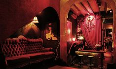 a living room filled with furniture and red lighting