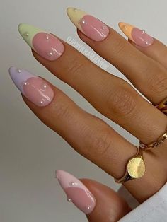 pastel French tips with pearls French Nails Easter, Easter Nail Inspo 2024, Easter Inspired Nails Acrylic, Almond Nails Designs Easter, Easter Nail Designs French Tips Pastel Colors, Cute Pastel French Tip Nails, Easter Nails Acrylic Pastel Almond, Trendy Pastel Nails Almond, Easter Colored Nails