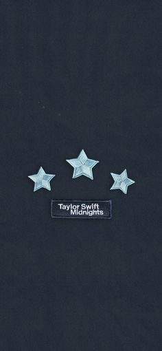 three silver stars on a black background