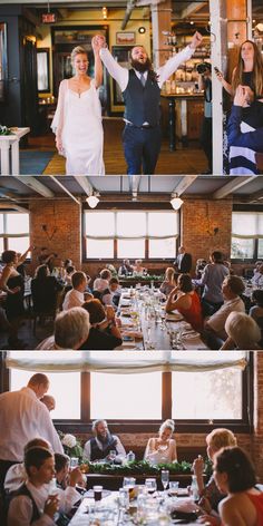 people sitting at tables in a restaurant with their hands up to the sky and one person standing