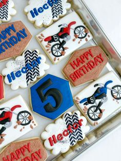 decorated cookies in the shape of numbers are arranged on a tray for a 5 - year birthday