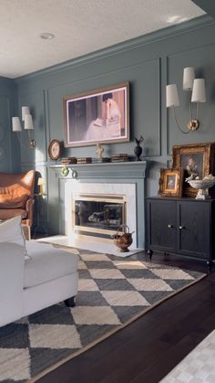 a living room filled with furniture and a fire place next to a painting on the wall