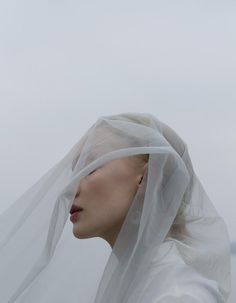 a woman with white veil on her head