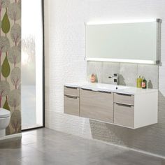 a bathroom with a toilet, sink and mirror in it's center wall area