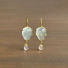 Enchanting hues of icy blue swell with each swing of these sensational aquamarine earrings with fanciful moonstone drops.

18k yellow gold 
Aquamarine 10mm x 15mm (3/8" x 9/16")
Moonstone 4mm x 6mm (3/16" x 1/4") 
Earrings hang 1 3/8" from the ear 
Each earring weighs 2.5g

#futureheirlooms #finejewelry #jewelrydesign #jotd #goldjewelry #goldsmith #benchjeweler #gemstonejewelry #jewelrylover #jewelrycollector Moonstone Cabochon, Aquamarine Earrings, Icy Blue