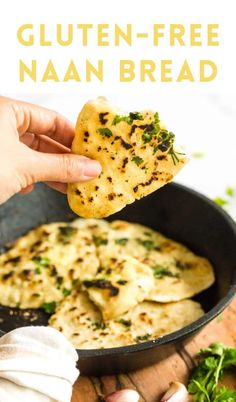 a person holding up a piece of bread with cheese and herbs on it in a skillet