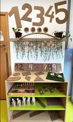 a display case with numbers and plants on the shelves in front of a sign that reads 1235