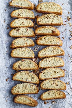 there are many pieces of bread on the blue tablecloth with nuts and other things