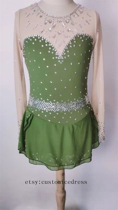 a green and white dress on a mannequin headdress with sequins