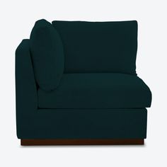 a dark blue couch with wooden legs