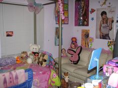 a child's bedroom is decorated in pastel colors and with stuffed animals on the bed