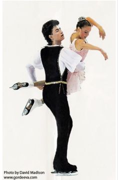 a man and woman in ballet clothes standing next to each other