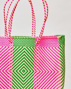 Don’t be fooled by the delicate weaving, this light-weight, long-handled bag can go anywhere. Pack it with a laptop and books for work, a bathing suit and towel for the beach, or use it as a carryon with a medley of items. Pink Square Beach Bag For Vacation, Square Pink Beach Bag For Vacation, Green Square Straw Bag For Vacation, Green Square Beach Bag For Vacation, Green Basket Bag For Beach Season, Rectangular Handwoven Beach Bag For Travel, Green Basket Shoulder Bag For Travel, Green Basket Beach Bag For Travel, Green Woven Beach Bag For Travel