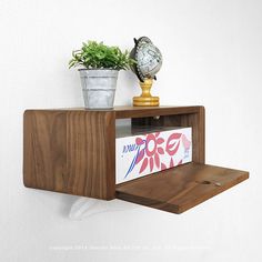 a shelf that has some plants on top of it and a clock in the corner