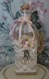 a bottle with lace and flowers in it