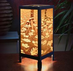 a lamp that is sitting on top of a wooden table next to a potted plant