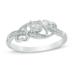 a white gold engagement ring with diamonds on the band and an intricate knot around it