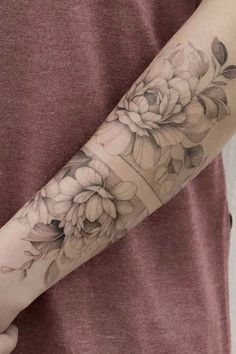 a woman's arm with flowers on it