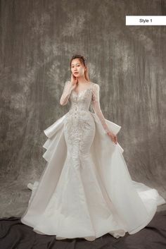 a woman in a white wedding dress posing for the camera with her hands on her face