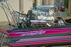 a pink and black boat with an engine