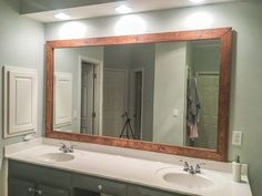 a bathroom with two sinks and a large mirror