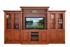 an entertainment center with wooden cabinets and a flat screen tv mounted on it's wall