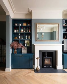 a living room filled with furniture and a fire place in front of a tv mounted on a wall