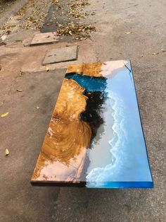 a table that has been made to look like it is floating in the water with blue and yellow paint