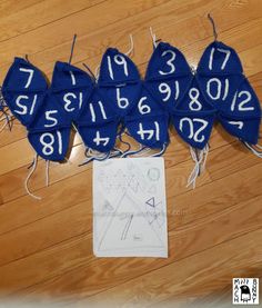 several pieces of blue cloth with numbers on them sitting next to a piece of paper