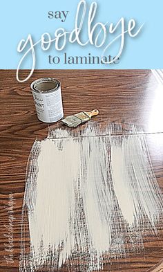 the words say goodbye to laminate on top of a wooden table with white paint