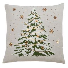 a white christmas tree pillow with gold stars on it