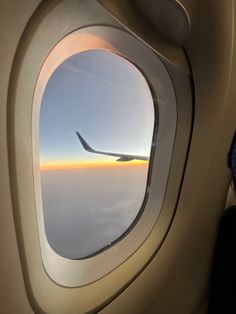 an airplane window looking out at the sky