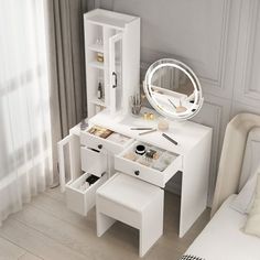 a white dressing table with drawers, mirror and stools next to a bed in a room