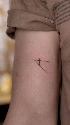 a person with a small tattoo on their arm