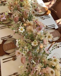 the table is set with white and pink flowers