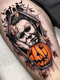 a man's leg with a skull and pumpkin on it