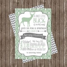 a baby shower is shown with a deer on it's back and green chevrons