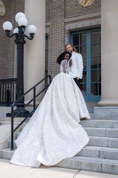 a man and woman are standing on some steps