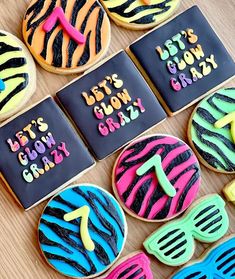 decorated cookies are arranged on a table with sunglasses and the words let's glow crazy