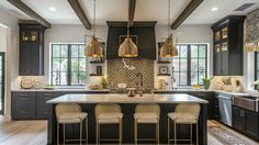 a large kitchen with black cabinets and gold pendant lights hanging from the ceiling, along with bar stools